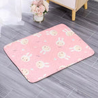 Pink rug with cartoon bunny designs on a gray floor.