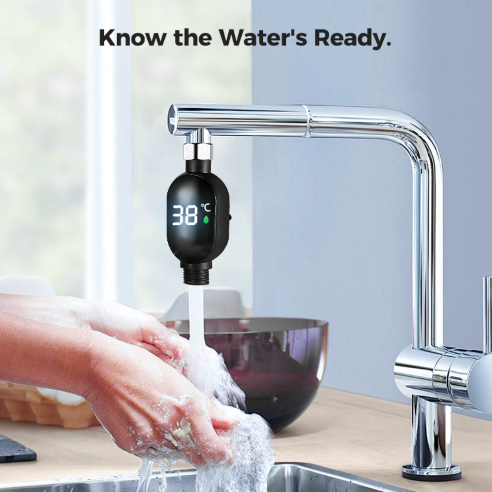 Faucet with digital temperature display showing 38 degrees Celsius, hands washing in a sink.