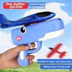 Toy gun with a small airplane attached, aimed at a blue sky background.