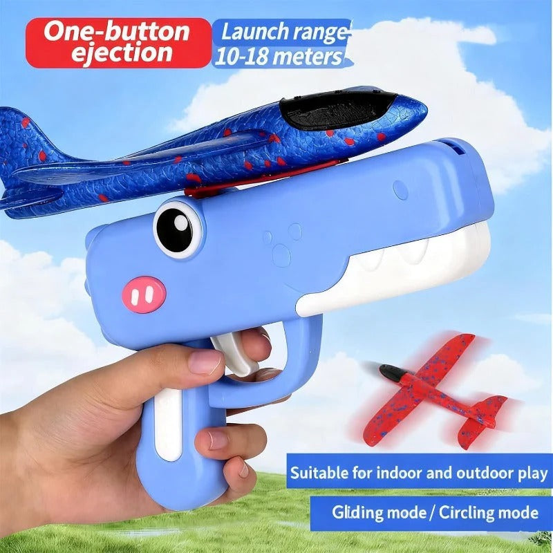 Toy gun with a small airplane attached, aimed at a blue sky background.