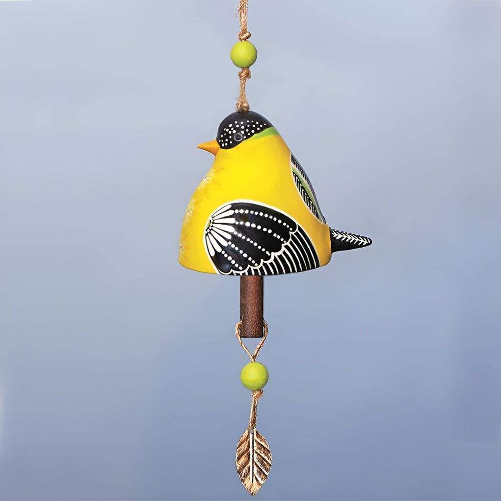 Decorative bird-shaped wind chime with yellow, black, and green colors on a light blue background.