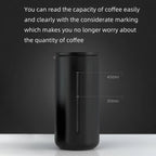 Black coffee tumbler with capacity markings on a dark background