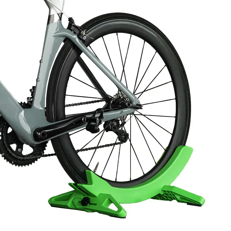 Bicycle on a green stand with a white background