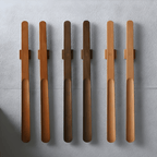 Set of six wooden spoons with metal handles on a gray surface