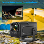 Portable outdoor projection device with people watching a movie on a screen in the background.