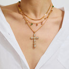 Gold necklace with a cross pendant on a white background