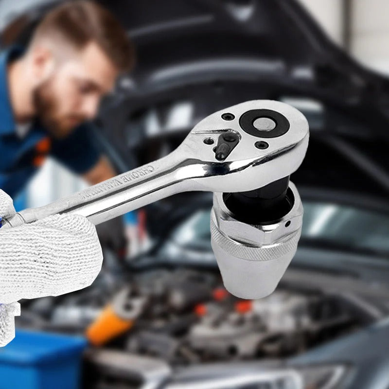 Close-up of a ratchet wrench with a blurred background of a person working on a car engine.