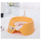 Yellow pet bed with a small white bowl on a white surface