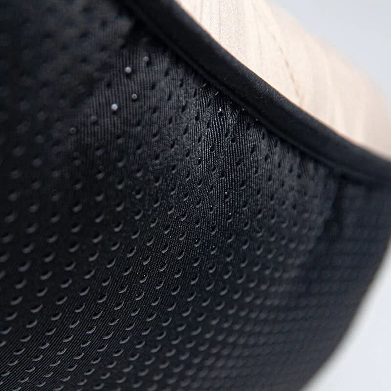 Close-up of a black textured fabric surface with a blurred background