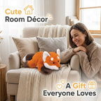 Woman sitting on a couch with a plush fox toy, surrounded by cozy decor elements.