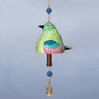 Decorative bird-shaped bell with colorful design on a gray background