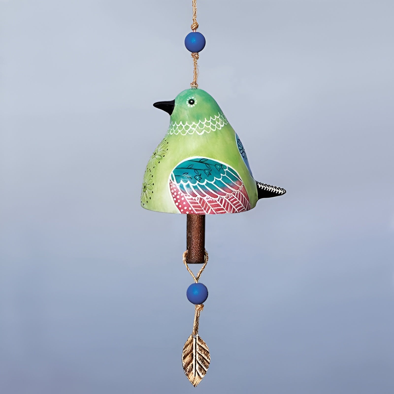 Decorative bird-shaped bell with colorful design on a gray background