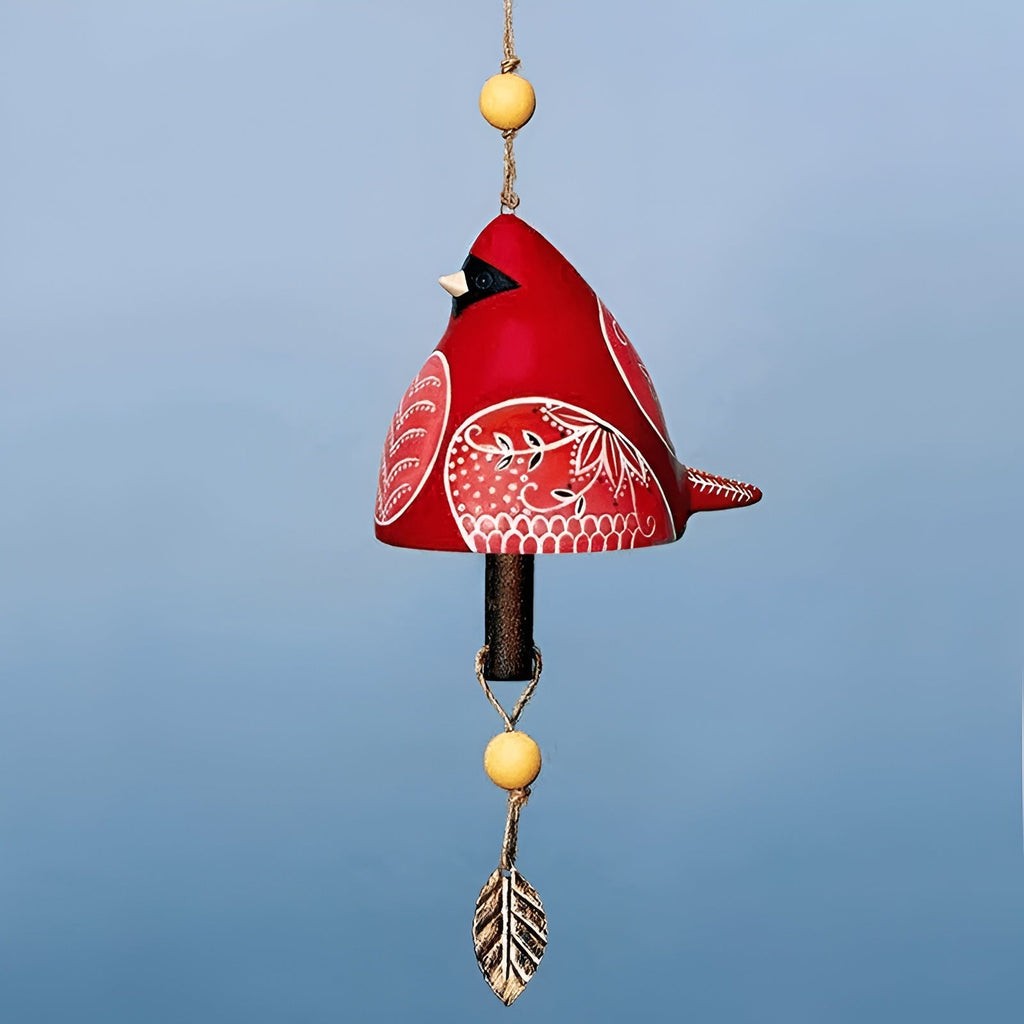 Red bird-shaped ornament with white patterns on a blue background
