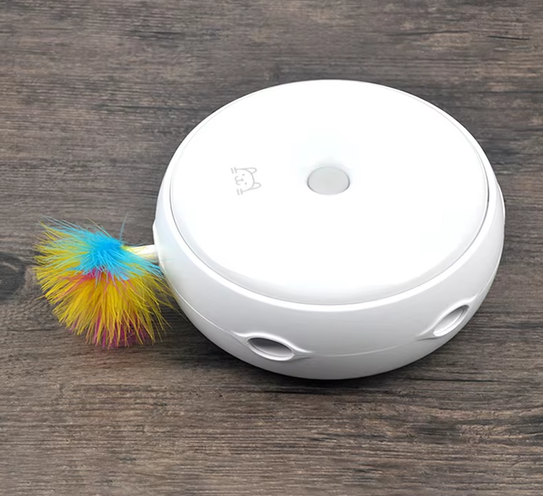 White electronic device with colorful feather on a wooden surface