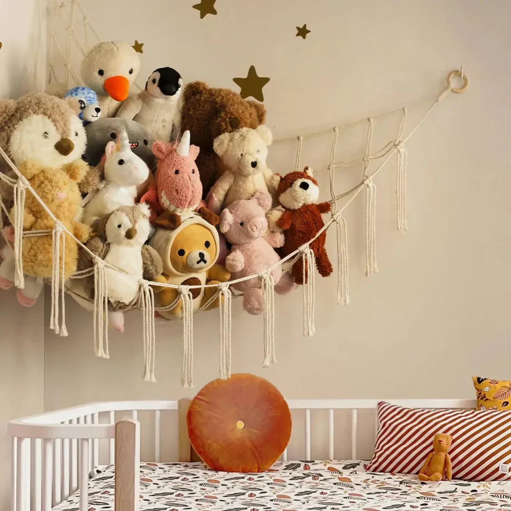 Children's room with stuffed animals on a macrame wall hanging above a crib.