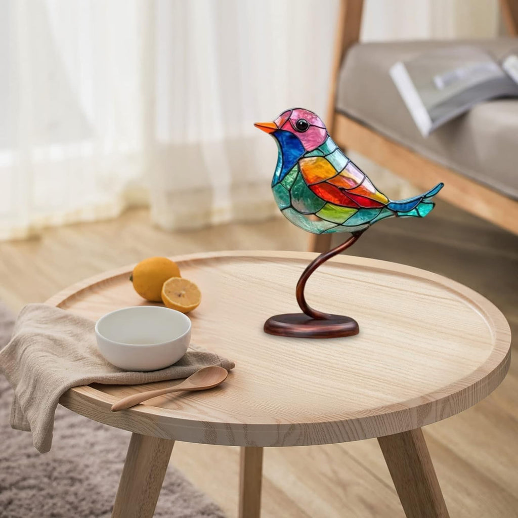 Colorful bird-shaped lamp on a wooden table with a bowl and lemon.