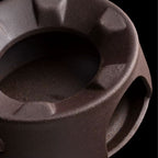 Close-up of a dark brown ceramic pot with textured surface