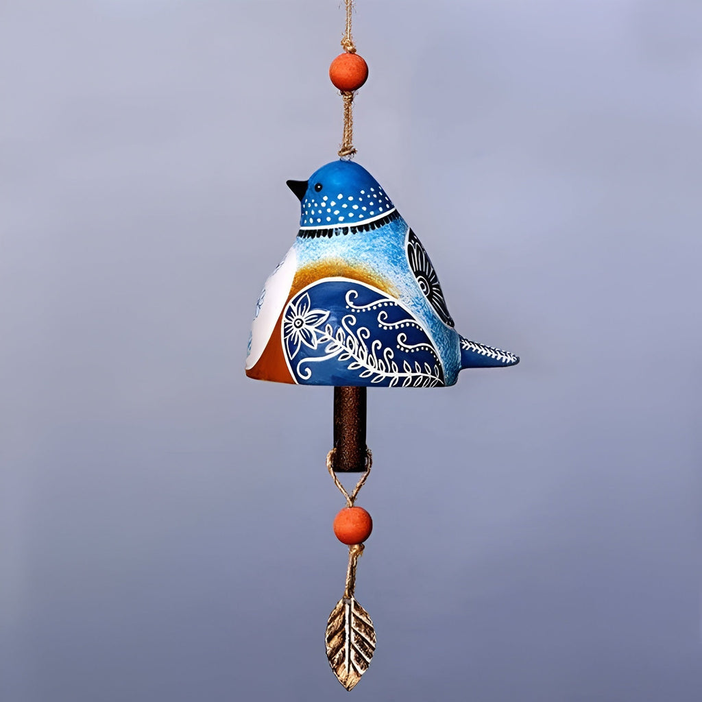 Decorative wind chime shaped like a blue bird with orange accents on a plain background