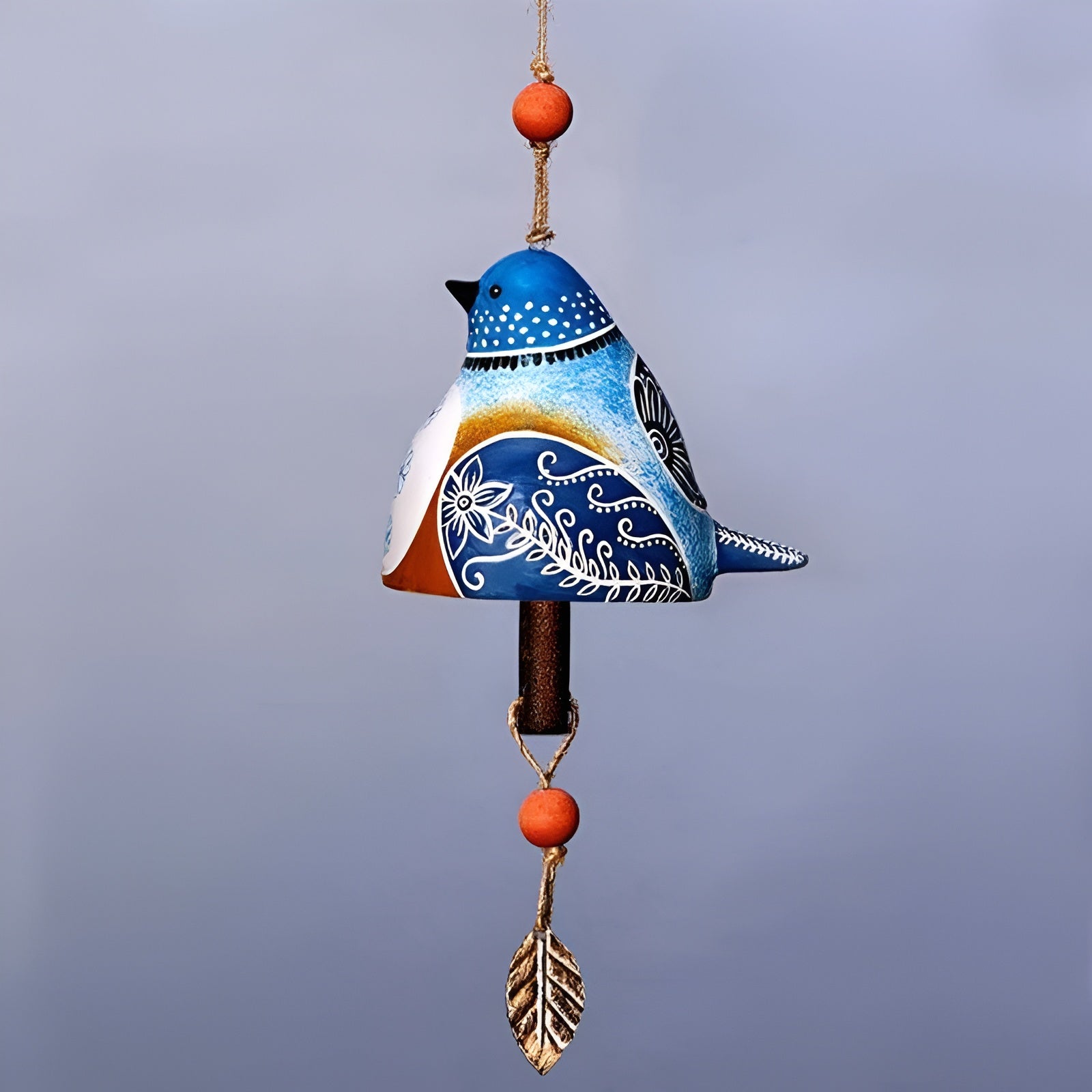 Decorative wind chime shaped like a blue bird with orange accents on a plain background