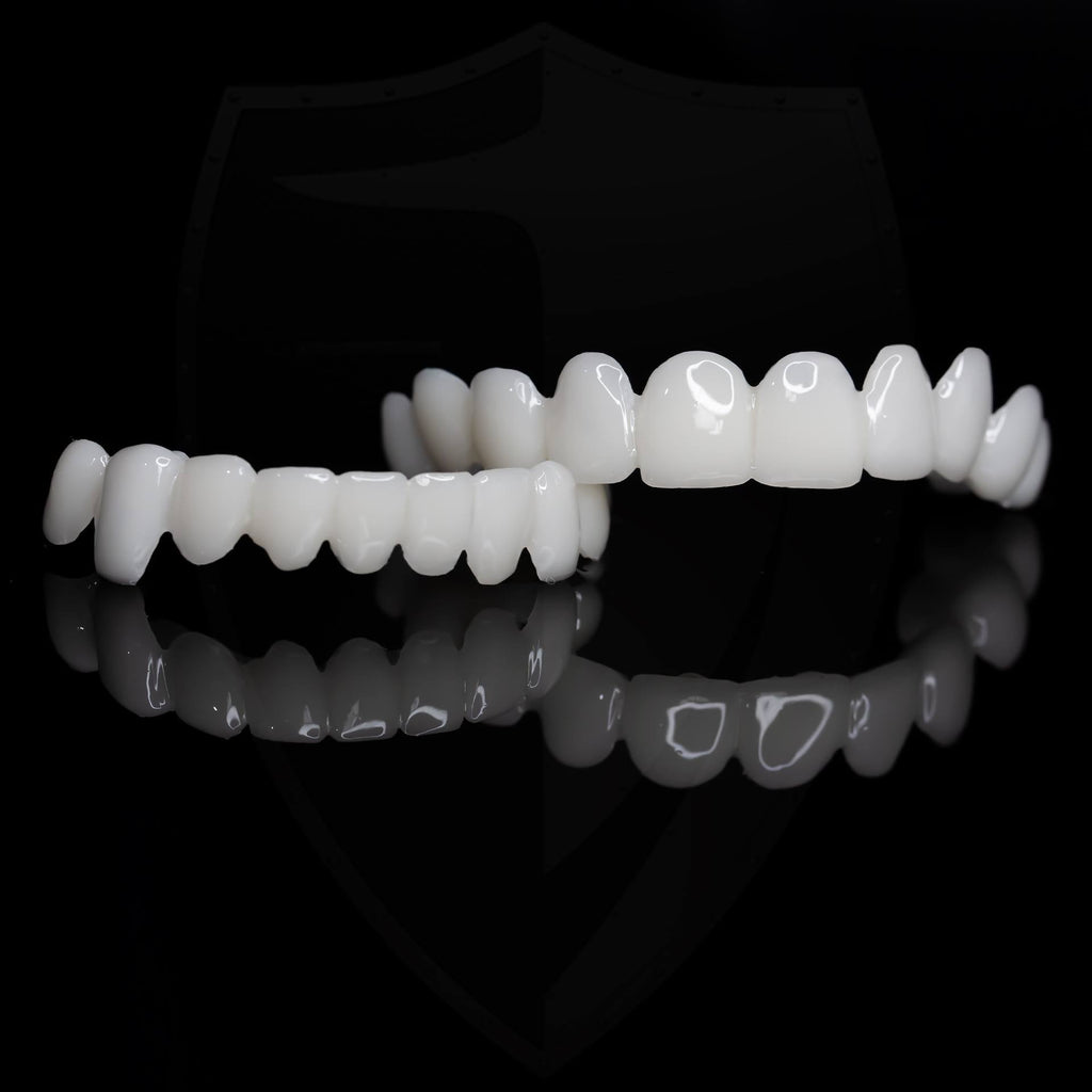 Set of white dental aligners on a black background