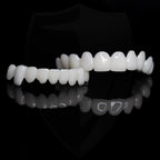 Set of white dental aligners on a black background