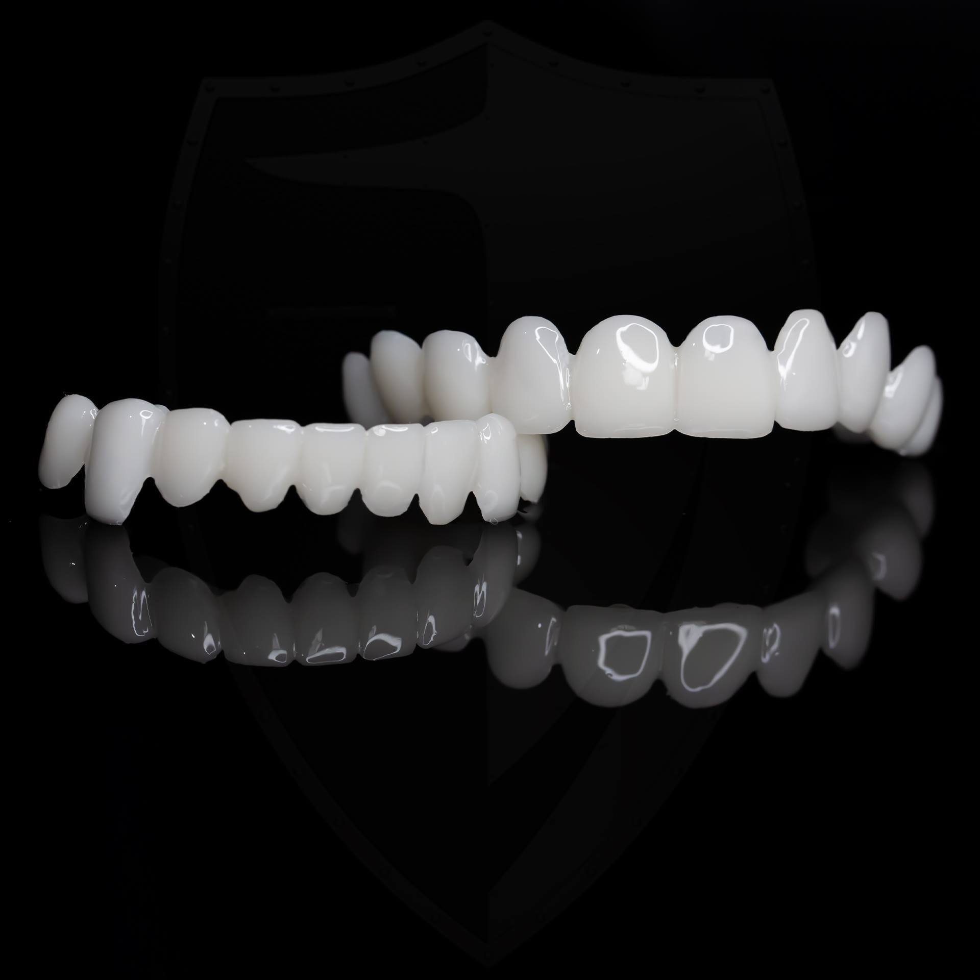 Set of white dental aligners on a black background