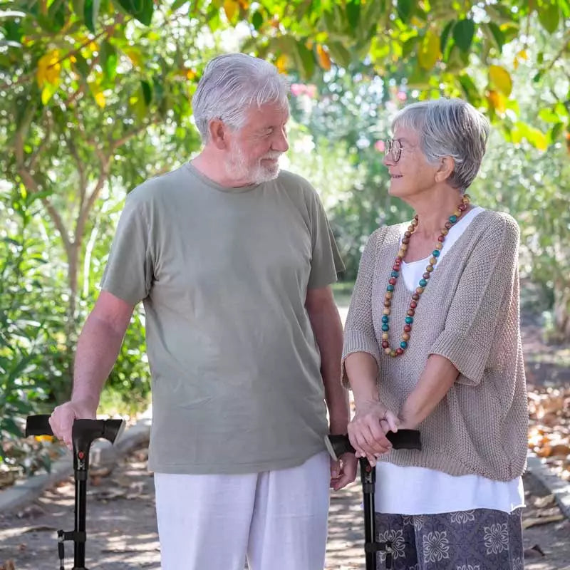 Senior couple holding hands in a garden setting