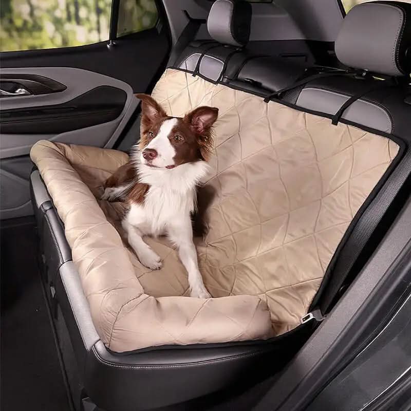 Dog sitting on a beige car seat cover in a vehicle