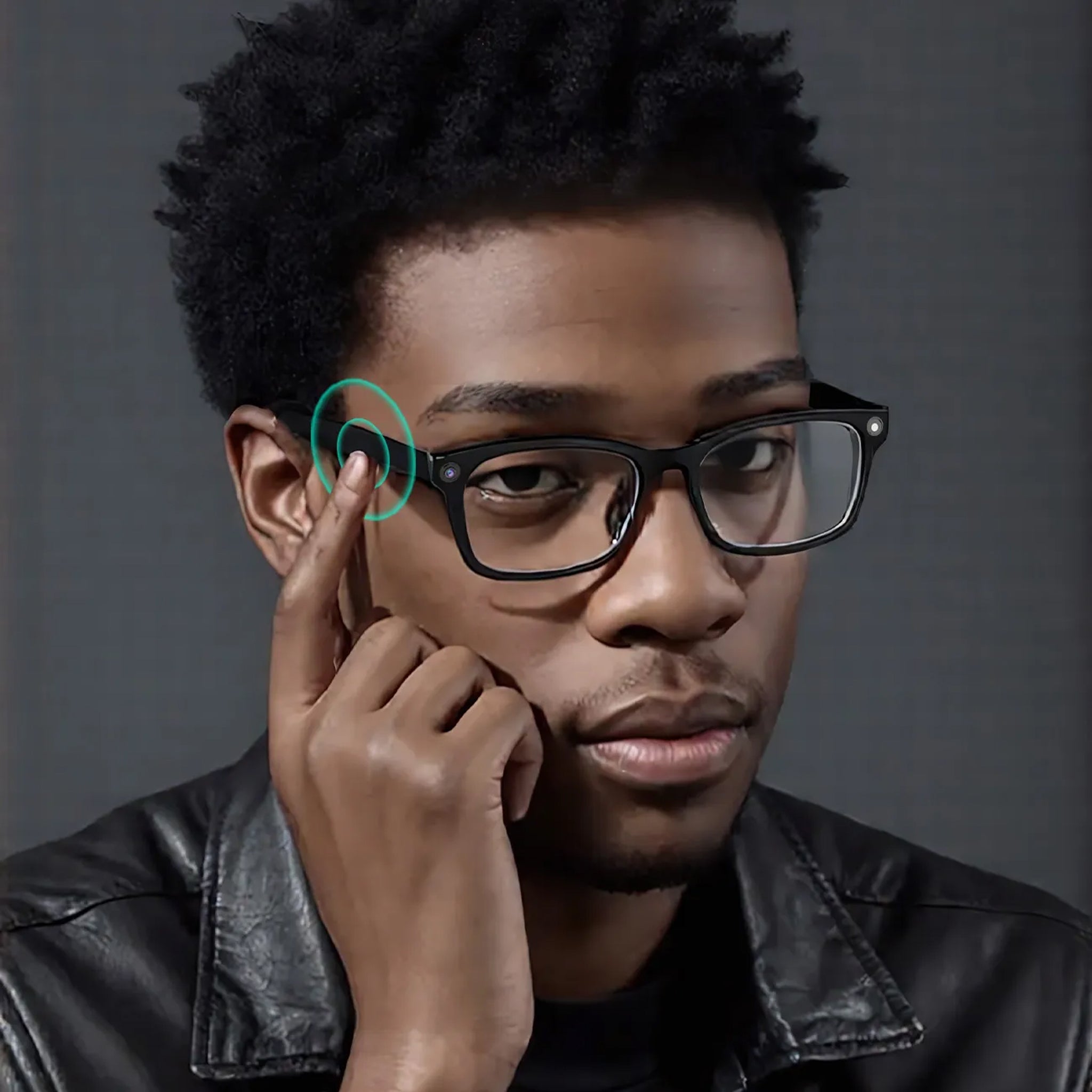 Man adjusting glasses with a gray background