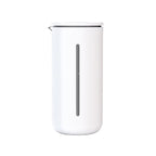 White milk frothing pitcher with a silver spout on a white background