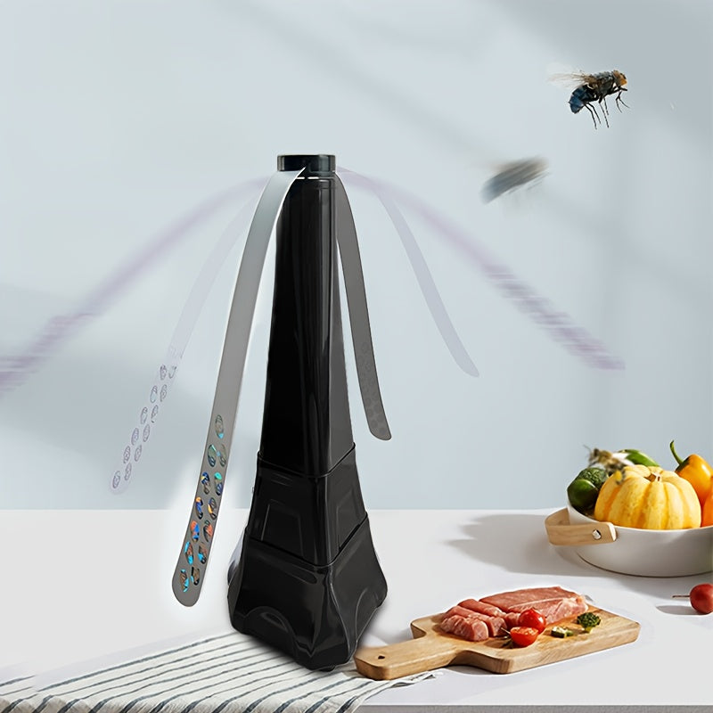 Black fly swatter on a kitchen counter with food and a fly in the background