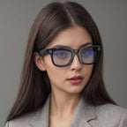 Woman wearing black glasses with a gray background