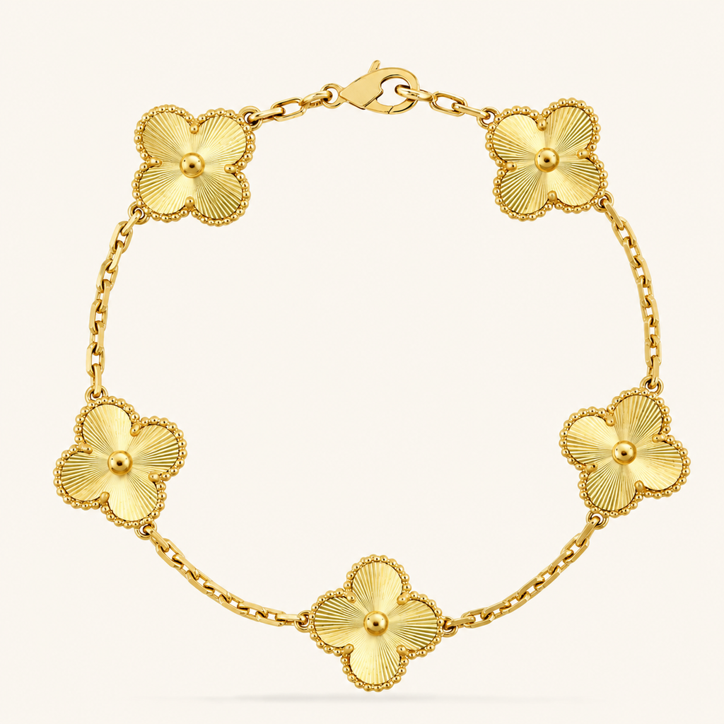 Gold bracelet with floral designs on a white background