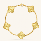 Gold bracelet with floral designs on a white background