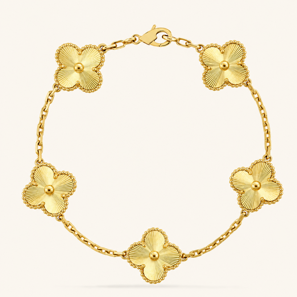 Gold bracelet with floral designs on a white background