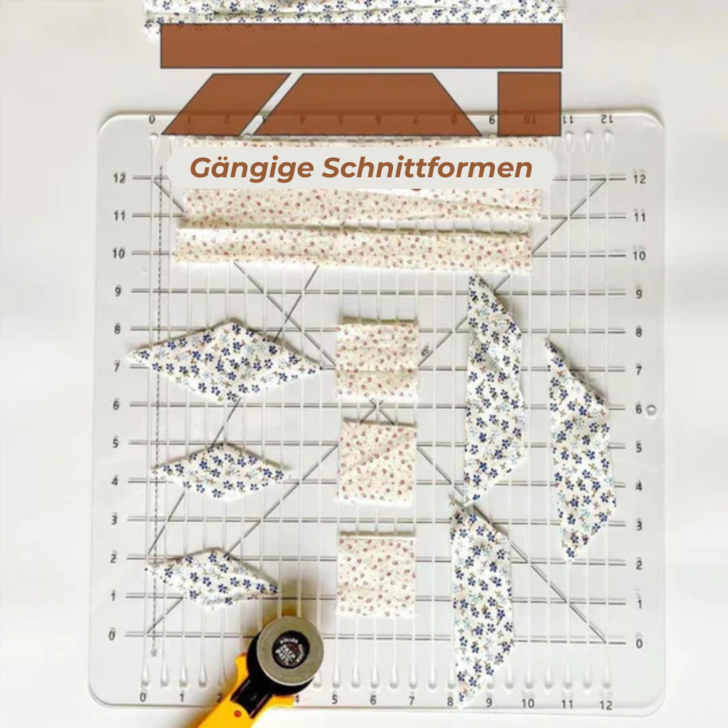 Quilting ruler with patterned fabric pieces and a rotary cutter on a white background