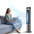 Woman sitting on a couch with a tower fan blowing air towards her