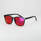 Sunglasses with red-tinted lenses on a light gray background