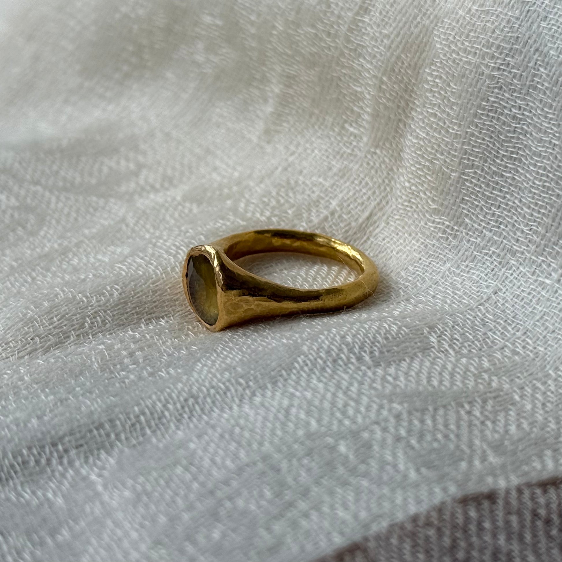 22ct Gold ring on a textured white fabric background