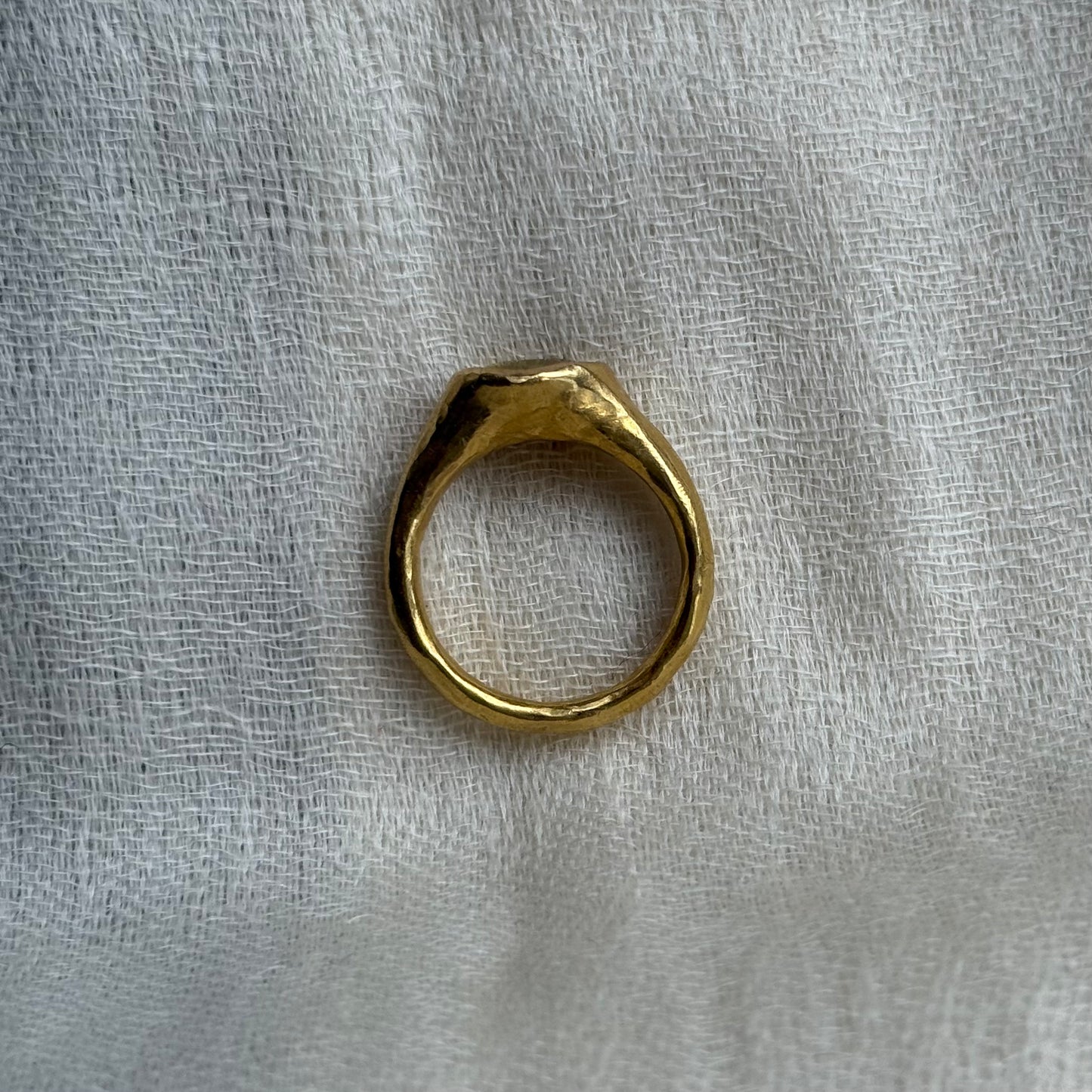 22ct Gold ring on a textured white fabric background