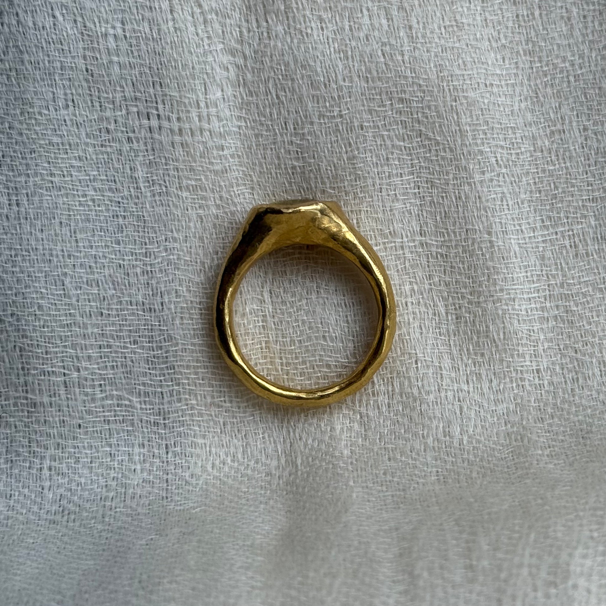 22ct Gold ring on a textured white fabric background